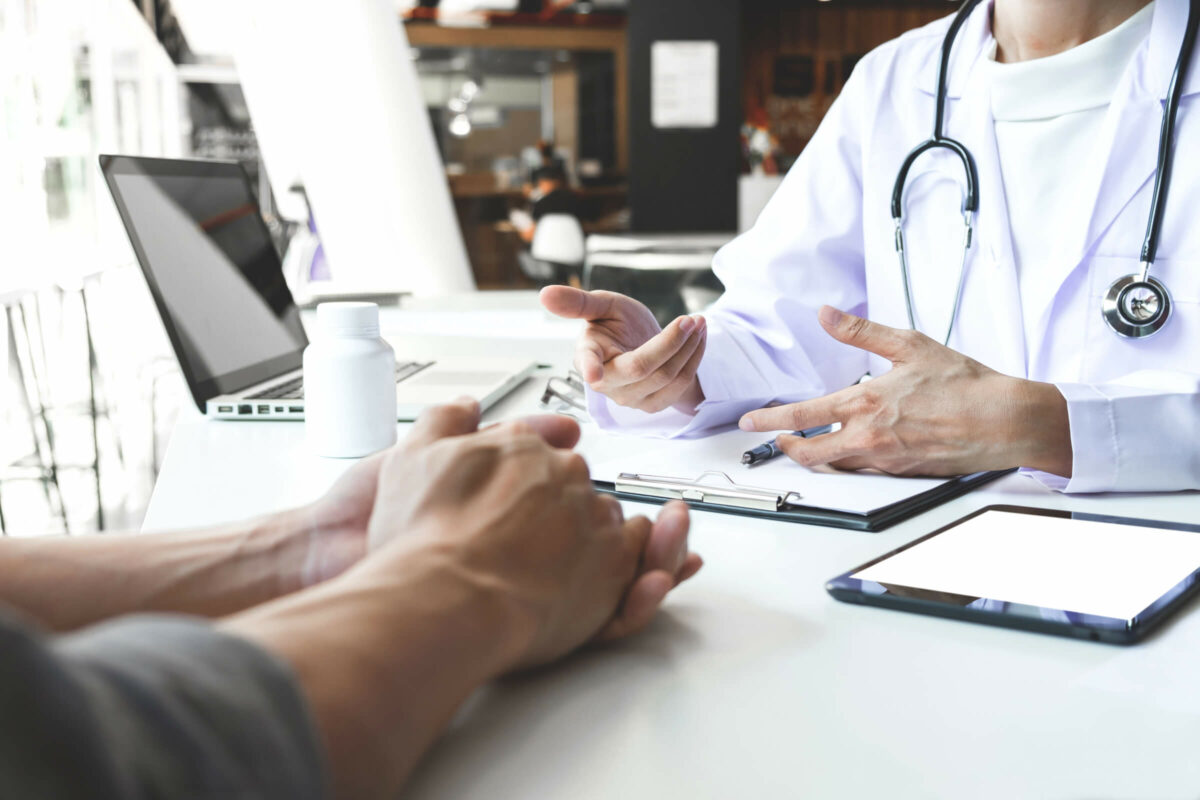 Medical professional discussing paperwork to an individual.